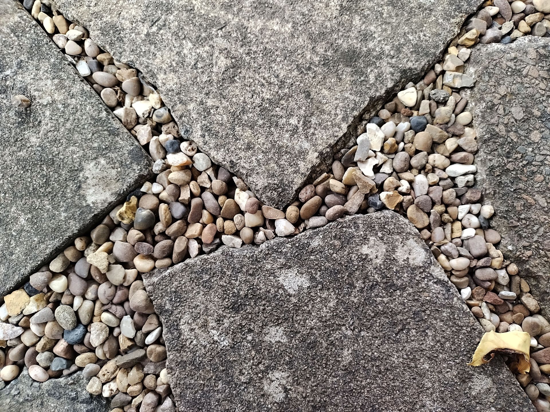 Close-up of stone pavement and pebbles forming a textured pattern.